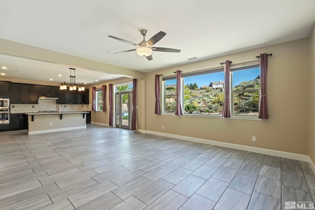 1680 Verdi Vista Ct, Reno, NV 89523 - unfurnished living room featuring a ceiling fan, recessed lighting, a chandelier, and wood tiled floors
