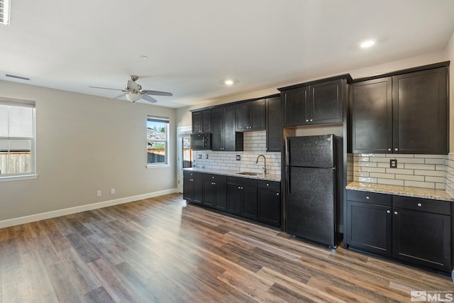 1680 Verdi Vista Ct, Reno, NV 89523 - kitchen with black appliances, a ceiling fan, wood finished floors, decorative backsplash, and recessed lighting