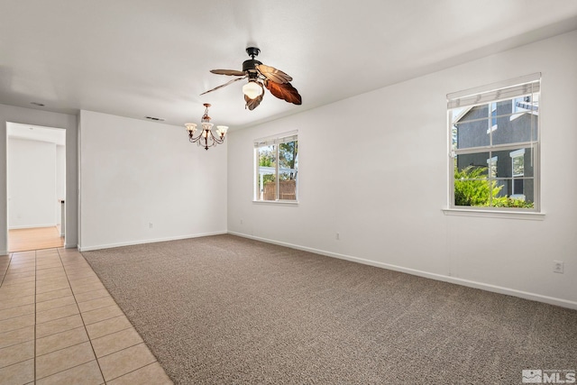 10655 Birch Point Ct, Reno, NV 89521 - empty room with a chandelier, light tile patterned flooring, baseboards, a ceiling fan, and light carpet