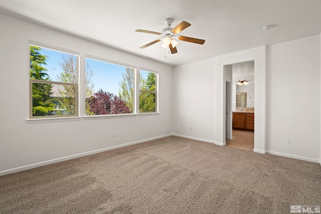 10655 Birch Point Ct, Reno, NV 89521 - empty room featuring light carpet, plenty of natural light, ceiling fan, and baseboards