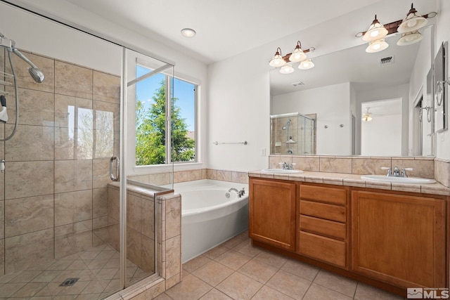10655 Birch Point Ct, Reno, NV 89521 - full bathroom featuring tile patterned flooring, double vanity, a bath, a shower stall, and ceiling fan