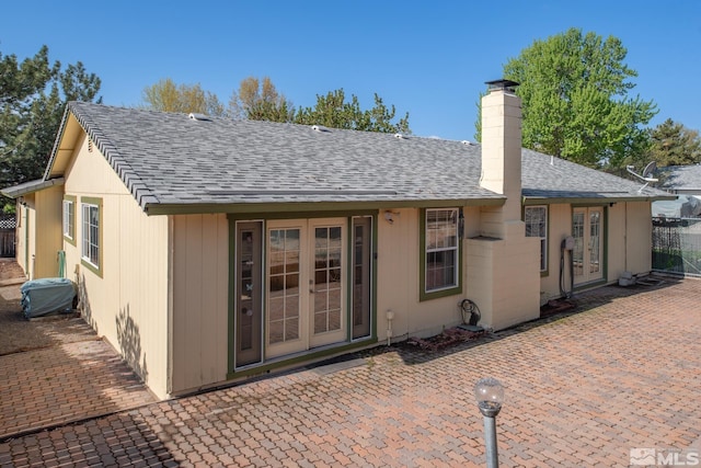 830 Lepori Way, Sparks, NV 89431 - rear view of house with french doors, a shingled roof, a chimney, and a patio