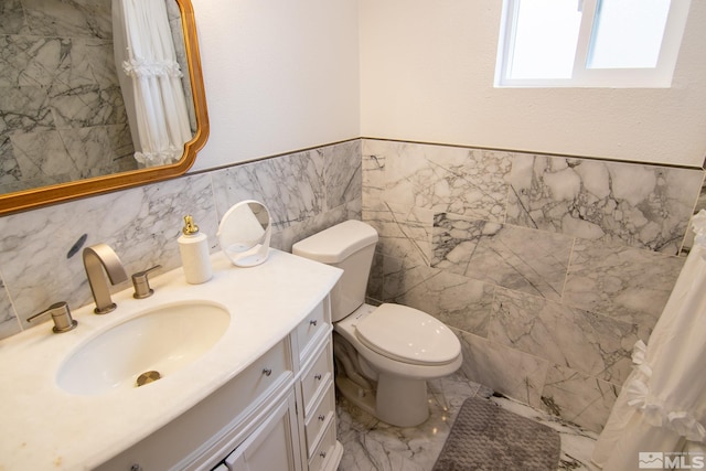 100 Bisset Ct Unit B, Reno, NV 89503 - bathroom featuring vanity, toilet, tile walls, and marble finish floors