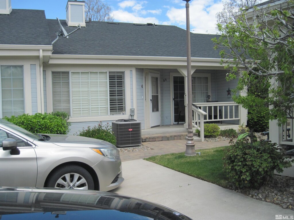 1420 N Douglas Unit 4, Gardnerville, NV 89410 - view of front facade with covered porch, cooling unit, and roof with shingles