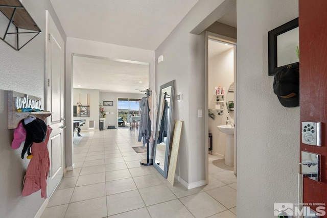 2449 Butte Creek Dr, Sparks, NV 89436 - hallway featuring light tile patterned flooring, a textured wall, and baseboards