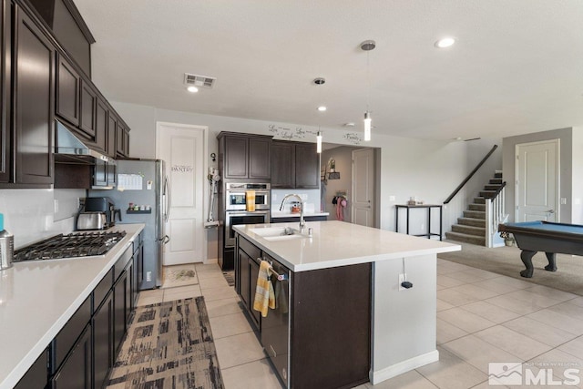 2449 Butte Creek Dr, Sparks, NV 89436 - kitchen featuring a sink, appliances with stainless steel finishes, light countertops, dark brown cabinets, and light tile patterned floors