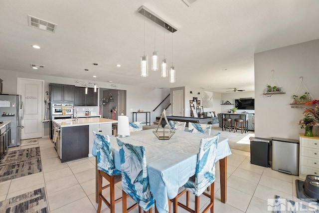 2449 Butte Creek Dr, Sparks, NV 89436 - dining space with light tile patterned floors, stairs, recessed lighting, and a ceiling fan