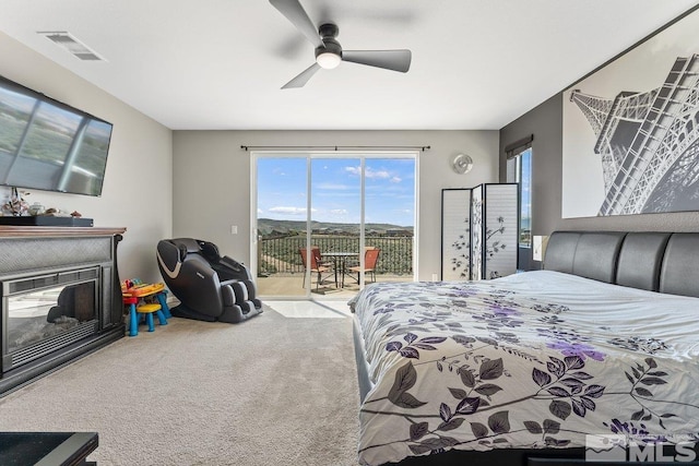 2449 Butte Creek Dr, Sparks, NV 89436 - bedroom with access to exterior, carpet, multiple windows, and a glass covered fireplace