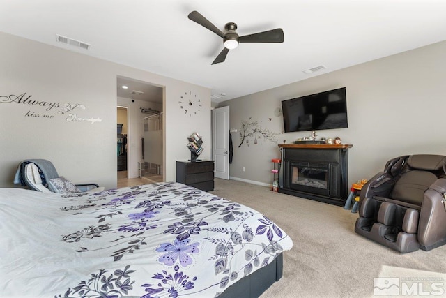 2449 Butte Creek Dr, Sparks, NV 89436 - carpeted bedroom with a glass covered fireplace, a ceiling fan, and a walk in closet