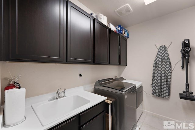 2449 Butte Creek Dr, Sparks, NV 89436 - laundry area featuring cabinet space, light tile patterned floors, independent washer and dryer, and baseboards