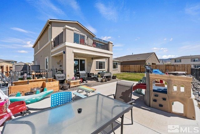 2449 Butte Creek Dr, Sparks, NV 89436 - rear view of property featuring a balcony, a fenced backyard, a patio, an outdoor living space, and stucco siding