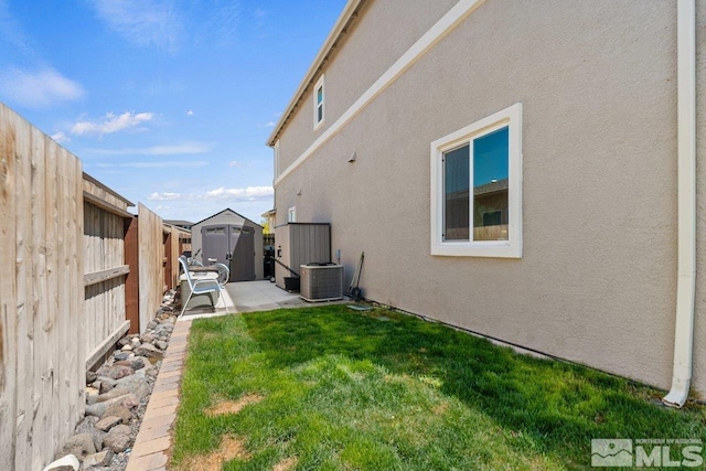 2449 Butte Creek Dr, Sparks, NV 89436 - view of yard with a storage shed, central AC unit, an outbuilding, and a patio