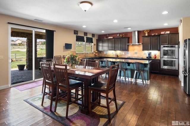 dining area with dark wood finished floors and recessed lighting