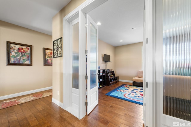 hall with hardwood / wood-style flooring, baseboards, recessed lighting, and french doors