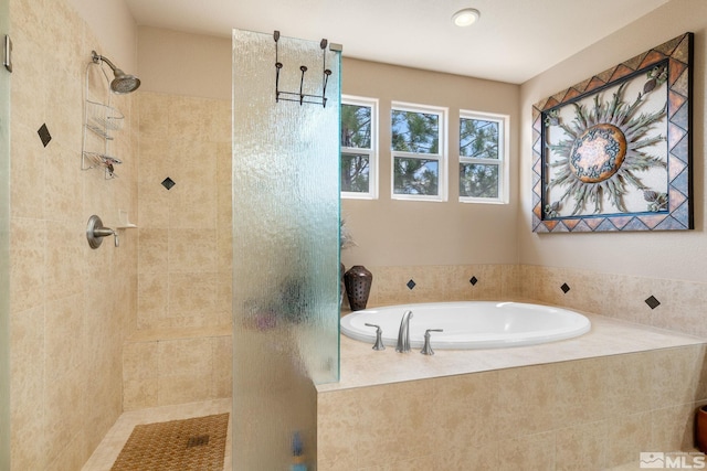full bath featuring a tile shower and a bath