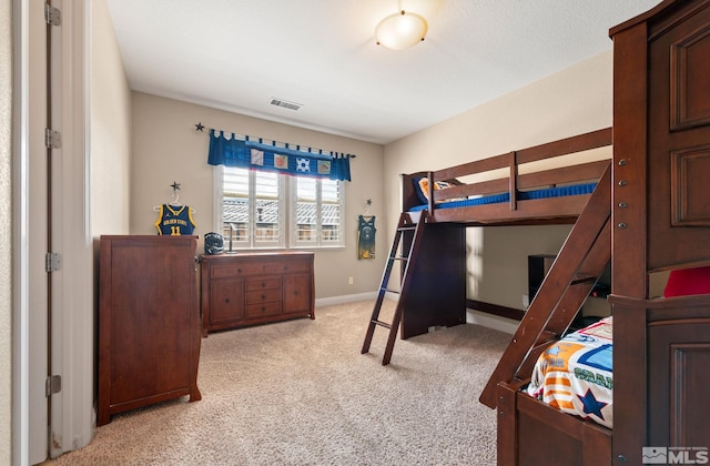 bedroom with light carpet and baseboards