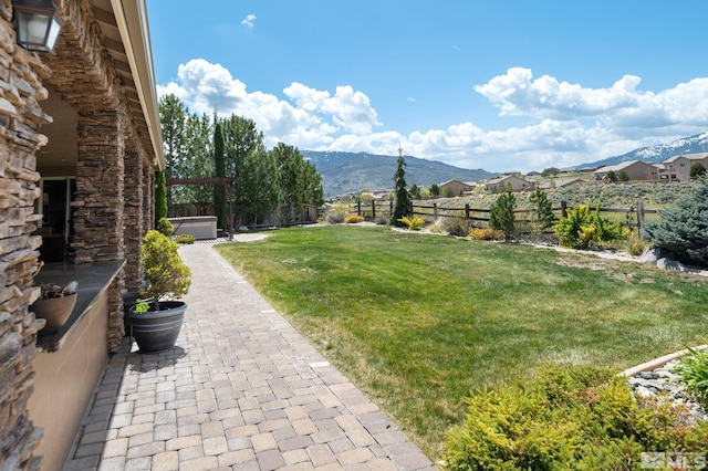 view of yard featuring a mountain view and a patio area