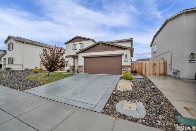 8853 Finnsech, Reno, NV 89506 - view of front of home with concrete driveway, a garage, board and batten siding, and stone siding