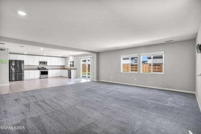 8853 Finnsech, Reno, NV 89506 - unfurnished living room with light carpet, recessed lighting, and light tile patterned floors