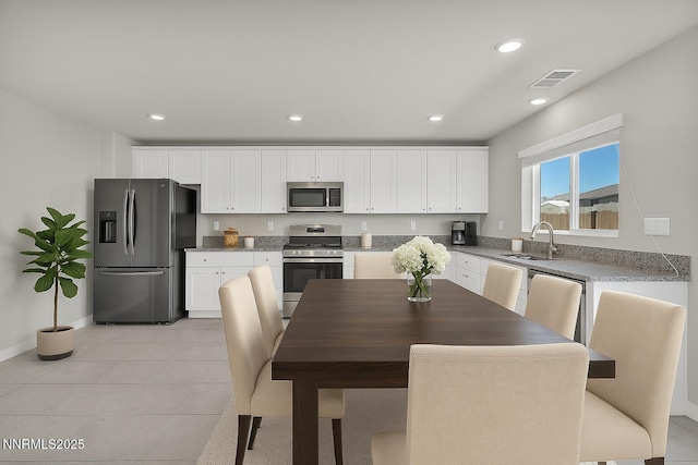 8853 Finnsech, Reno, NV 89506 - kitchen with appliances with stainless steel finishes, white cabinets, recessed lighting, and light tile patterned floors