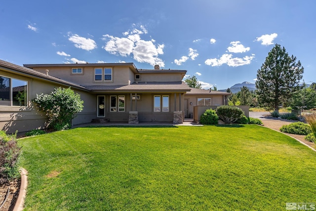 202 Paddington Ct, Reno, NV 89511 - back of property with stucco siding, a lawn, and a mountain view