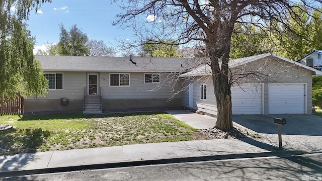 single story home with driveway, an attached garage, entry steps, and a front yard