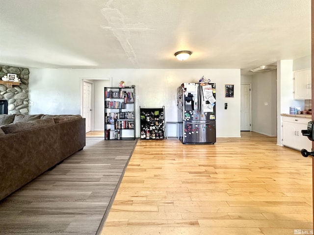 workout area with light wood-style flooring