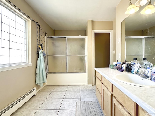 full bath with baseboard heating, vanity, shower / bath combination with glass door, and tile patterned floors