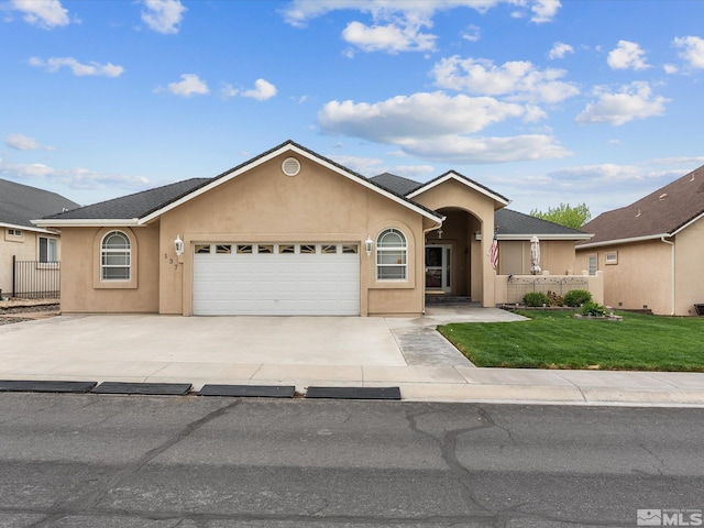 137 Desert Lakes Dr, Fernley, NV 89408 - ranch-style home featuring an attached garage, stucco siding, and concrete driveway