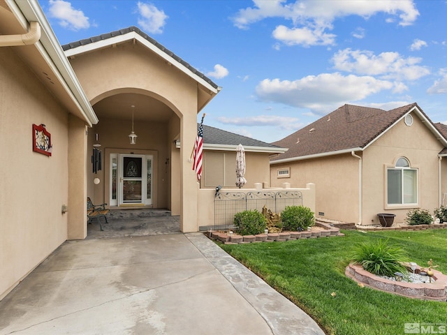 137 Desert Lakes Dr, Fernley, NV 89408 - property entrance with stucco siding and a yard