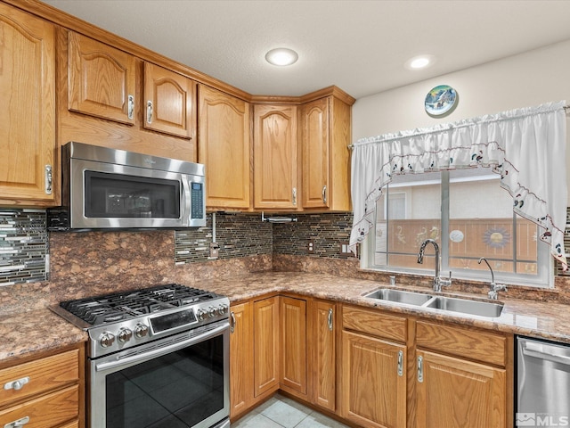 137 Desert Lakes Dr, Fernley, NV 89408 - kitchen with stainless steel appliances, a sink, tasteful backsplash, light tile patterned floors, and stone counters
