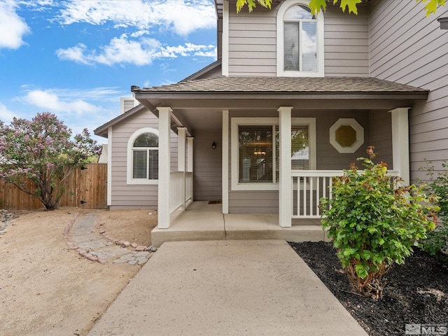 1820 Bogie Ct, Fernley, NV 89408 - doorway to property featuring covered porch, fence, and a shingled roof