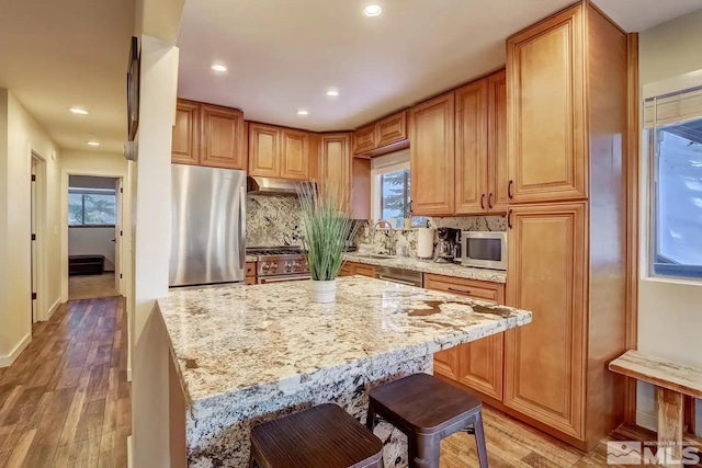 758 Milky Way Ct Unit E, Stateline, NV 89449 - kitchen featuring appliances with stainless steel finishes, a sink, light wood finished floors, decorative backsplash, and recessed lighting