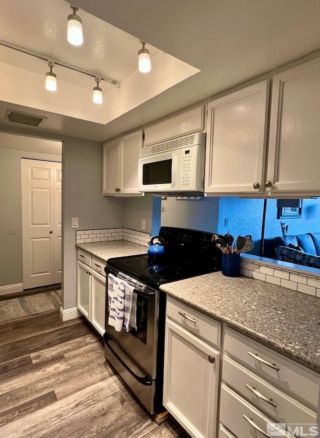 2855 Idlewild Dr Apt 124, Reno, NV 89509 - kitchen featuring white microwave, stainless steel range with electric cooktop, light wood-style floors, light stone counters, and white cabinets