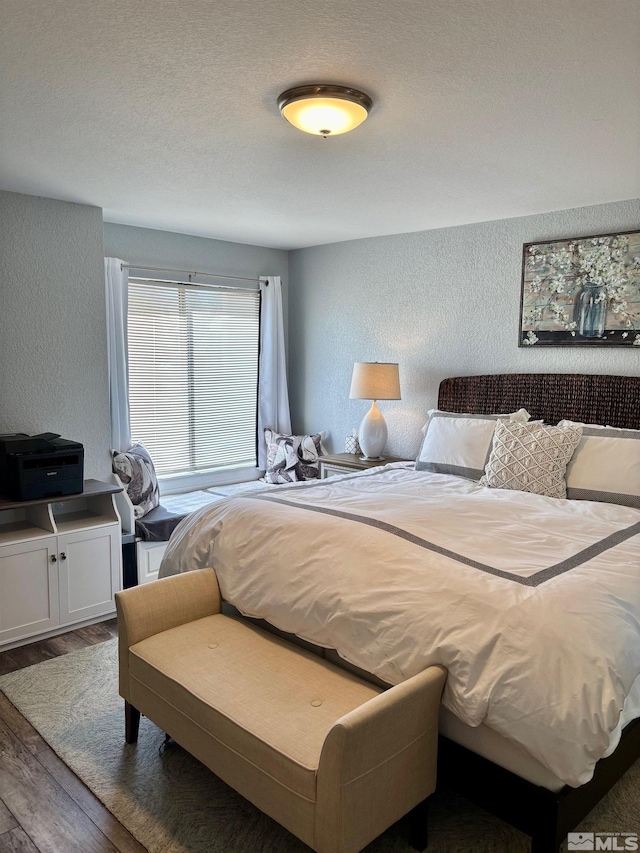 2855 Idlewild Dr Apt 124, Reno, NV 89509 - bedroom with a textured wall, wood finished floors, and a textured ceiling