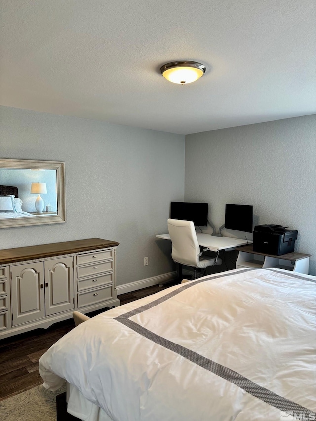 2855 Idlewild Dr Apt 124, Reno, NV 89509 - bedroom with dark wood-type flooring, a desk, and baseboards