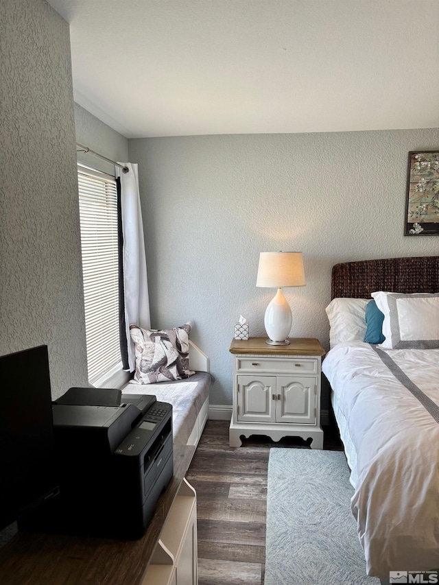 2855 Idlewild Dr Apt 124, Reno, NV 89509 - bedroom with dark wood-style floors, a textured wall, and baseboards