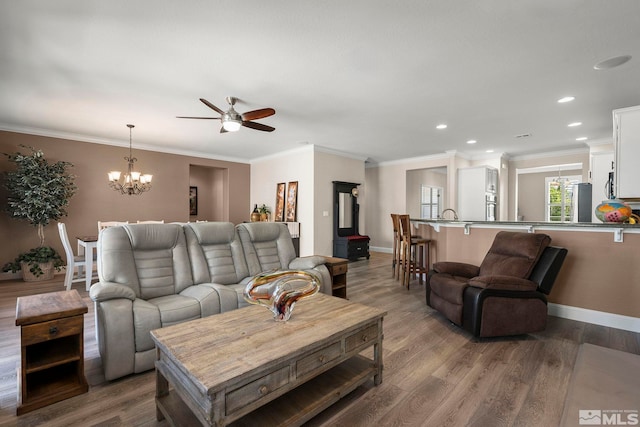 living area featuring a ceiling fan, wood finished floors, a chandelier, recessed lighting, and baseboards
