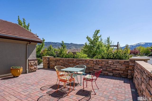 view of patio with a mountain view and outdoor dining space