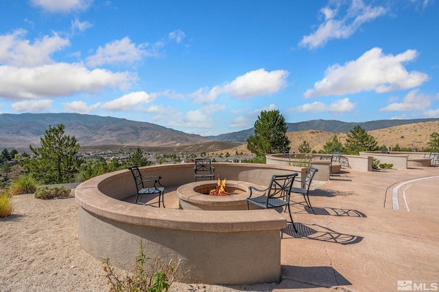 view of patio featuring a mountain view and a fire pit