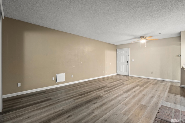 4941 Reggie Rd, Reno, NV 89502 - unfurnished living room featuring ceiling fan, wood finished floors, a textured ceiling, and baseboards