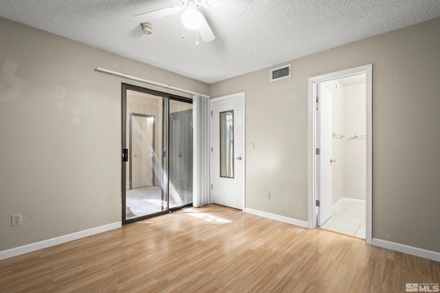 4941 Reggie Rd, Reno, NV 89502 - unfurnished bedroom featuring light wood finished floors, a textured ceiling, baseboards, and ceiling fan