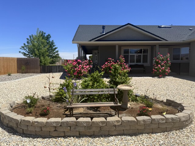 921 Red Rock Rd, Fernley, NV 89408 - back of property with a shingled roof and covered porch