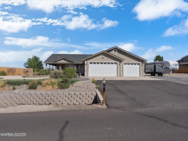 921 Red Rock Rd, Fernley, NV 89408 - ranch-style house featuring asphalt driveway and an attached garage