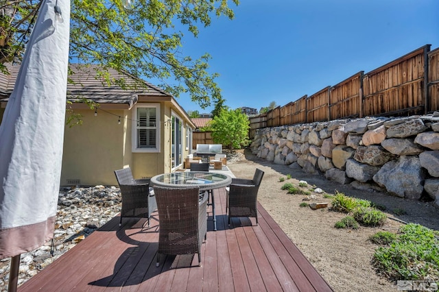 5132 Ironstone Cir, Sparks, NV 89436 - wooden deck with outdoor dining space and a fenced backyard