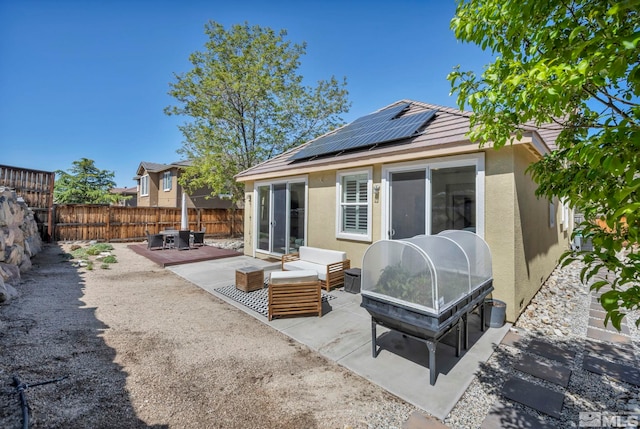 5132 Ironstone Cir, Sparks, NV 89436 - rear view of house with stucco siding, a fenced backyard, solar panels, an outdoor living space, and a patio area