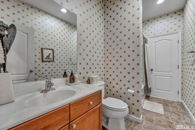 5132 Ironstone Cir, Sparks, NV 89436 - full bath featuring wallpapered walls, shower / bath combination with curtain, toilet, vanity, and stone finish floors