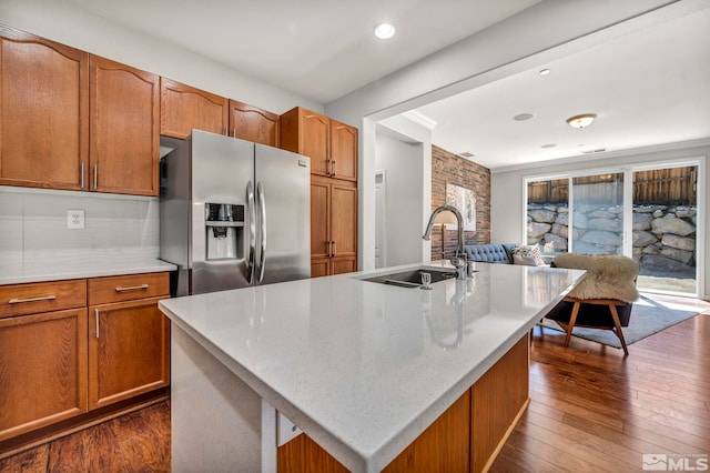 5132 Ironstone Cir, Sparks, NV 89436 - kitchen with stainless steel fridge with ice dispenser, a sink, brown cabinets, open floor plan, and dark wood-style flooring