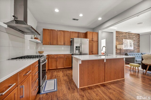 5132 Ironstone Cir, Sparks, NV 89436 - kitchen with wall chimney range hood, appliances with stainless steel finishes, a sink, dark wood-type flooring, and open floor plan