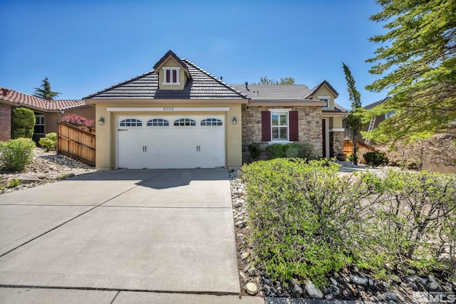 5132 Ironstone Cir, Sparks, NV 89436 - single story home with a garage, concrete driveway, a tiled roof, stone siding, and stucco siding